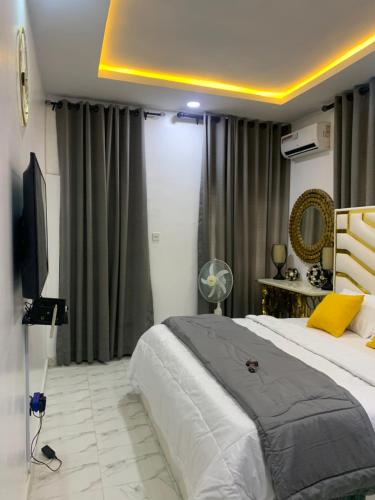 a bedroom with a large bed and a television at Beautiful single room studio apartment in Ilasan lekki magnanimous in Lekki