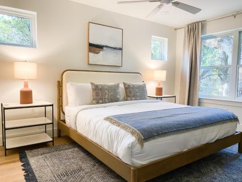 a bedroom with a large bed and two lamps at Camp Hideaway Gruene in New Braunfels