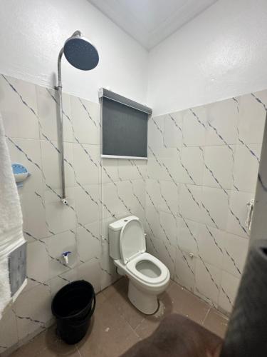 a bathroom with a white toilet and a window at Beautiful single room studio apartment in Ilasan lekki magnanimous in Lekki