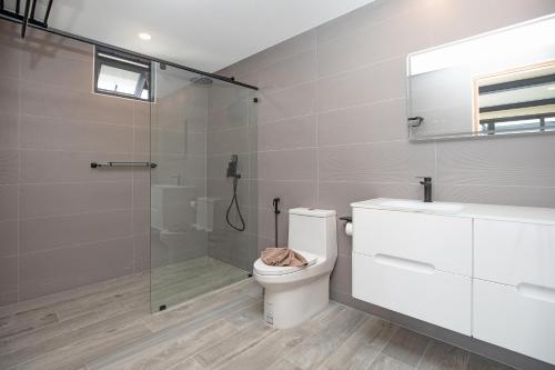 a bathroom with a toilet and a glass shower at New 2-Storey Villa*4BR*Eco-Pool Sunset Garden 8 in Ban Saiyuan (1)