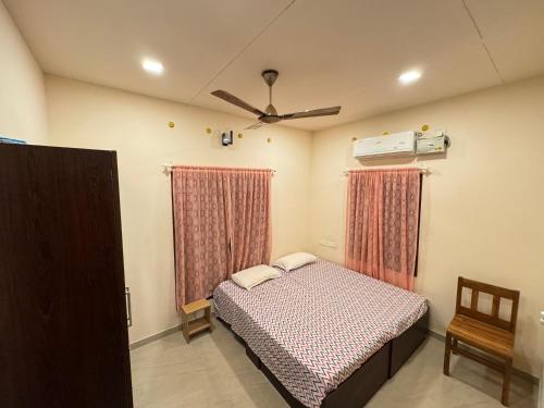 a bedroom with a bed and a ceiling fan at sacred river homestay in Alleppey
