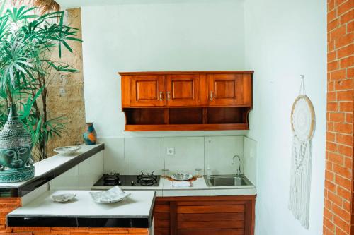 a kitchen with a sink and a counter top at Way Ubud House in Ubud