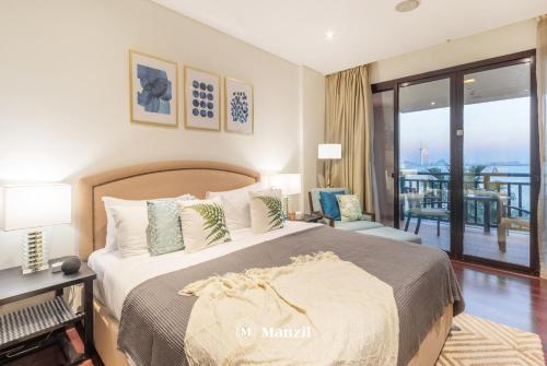 a bedroom with a large bed and a balcony at Manzil - 1BR in Anantara The Palm with Private Beach & Burj View, Palm Jumeirah in Dubai