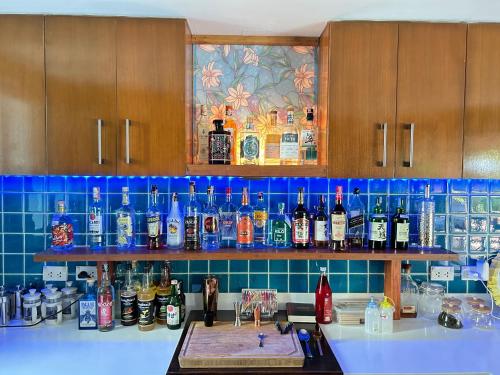 a kitchen counter with a bunch of bottles of alcohol at Nanai Resort Salakphet in Ko Chang