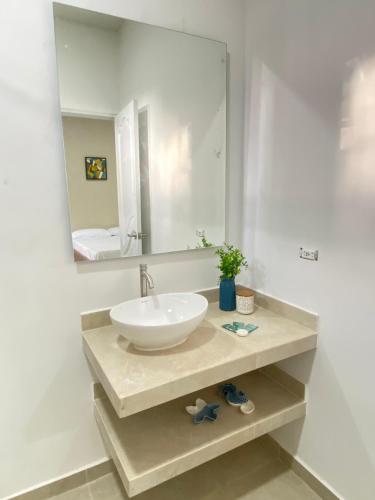 a bathroom with a sink and a mirror at Guakmaya hostel in Cartagena de Indias