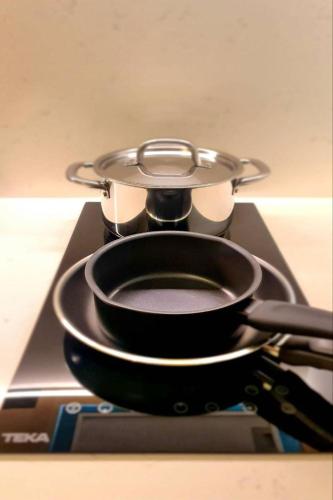 a pan sitting on top of a stove at The SACHA Apart-Hotel Thonglor in Bangkok