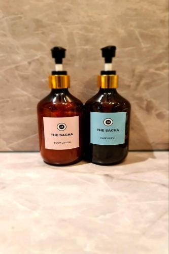 two bottles of soap sitting next to each other at The SACHA Apart-Hotel Thonglor in Bangkok