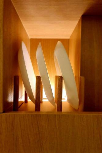 three knives sticking out of a wooden holder at The SACHA Apart-Hotel Thonglor in Bangkok