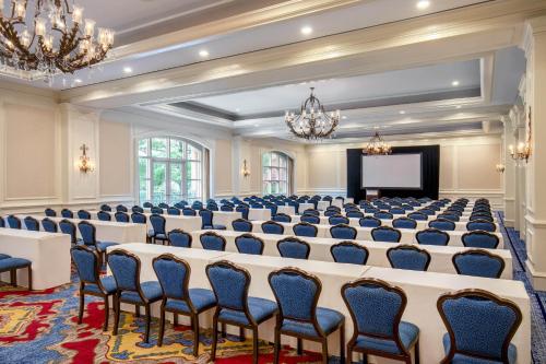 a large room with rows of chairs and a screen at The Westin Riverwalk, San Antonio in San Antonio