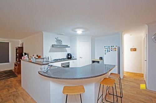 a kitchen with a island in the middle of a room at Fishface Retreat in Jurien Bay