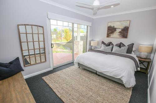 a bedroom with a bed and a sliding glass door at Sundown Country Club in Bright