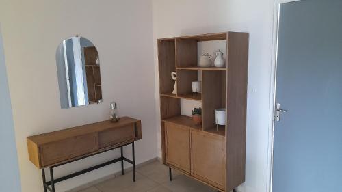y baño con tocador de madera y espejo. en RésidencesTYS, en Saint-Denis