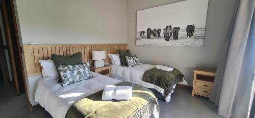 a bedroom with two beds and a couple of elephants at Highland gate Golf estate Mountain view 780 in Dullstroom