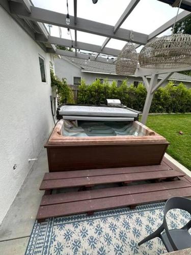 a hot tub sitting on the patio of a house at Beautiful 3 Bed Home with a Large Back Yard Outdoor Space in Los Angeles
