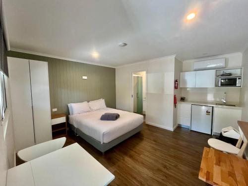 a hotel room with a bed and a kitchen at Young Caravan and Tourist Park in Young