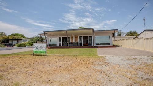 a house with a sign in front of it at Beachview in Coffin Bay