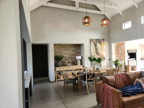 a living room with a couch and a table at Highland gate Golf estate Mountain view 780 in Dullstroom