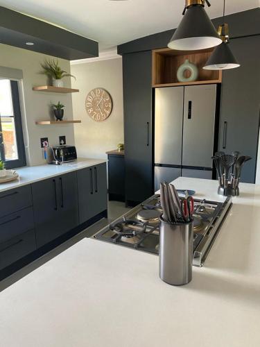 a kitchen with a stove and a counter top at Highland gate Golf estate Mountain view 780 in Dullstroom