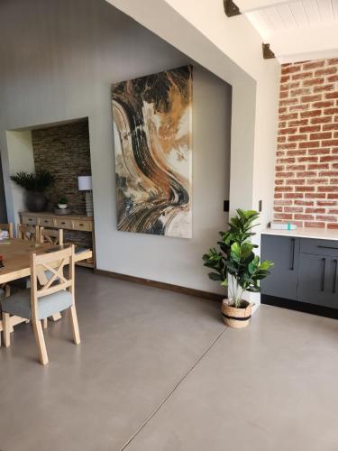 a dining room with a large painting on the wall at Highland gate Golf estate Mountain view 780 in Dullstroom