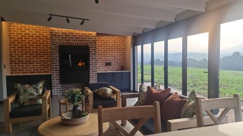 a living room with a couch and a fireplace at Highland gate Golf estate Mountain view 780 in Dullstroom