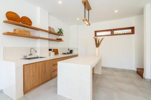 a kitchen with white walls and a white counter top at New Cozy 2-b Villa in Canggu in Munggu