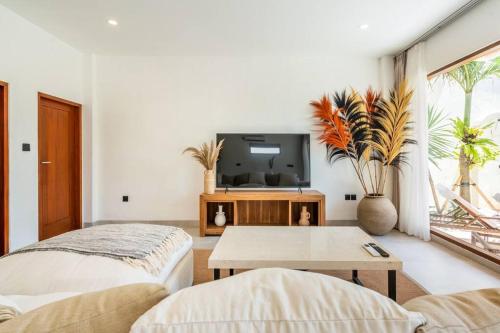 a living room with a tv and a table at New Cozy 2-b Villa in Canggu in Munggu
