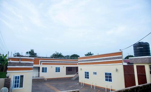 a row of buildings with a water tank on the roof at BryMac Hotel in Koforidua
