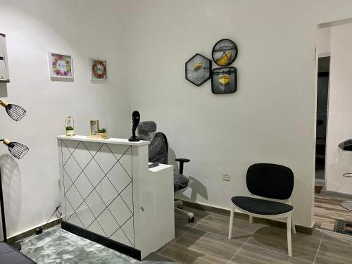 a room with a chair and a clock on the wall at BryMac Hotel in Koforidua