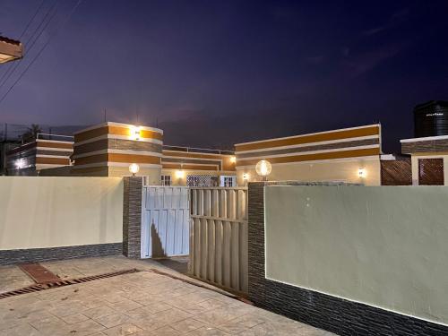 a house with a gate and a fence at night at BryMac Hotel in Koforidua