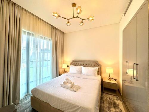 a bedroom with a bed with towels on it at Stylish brand new 1 bedroom in Dubai