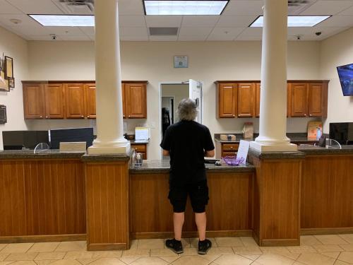 a man standing at a counter in a room at Disney 1 mile , Blue Heron 1 room 2 bath,amenities,6 guests, walk to restaurants, no fees at check in in Orlando