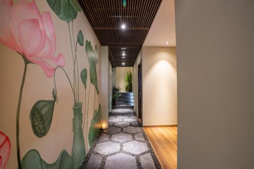 a hallway with a flower mural on the wall at Alagon Saigon Hotel & Spa in Ho Chi Minh City