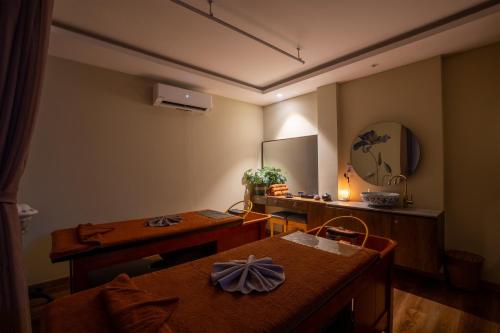 a dining room with a table and a mirror at Alagon Saigon Hotel & Spa in Ho Chi Minh City