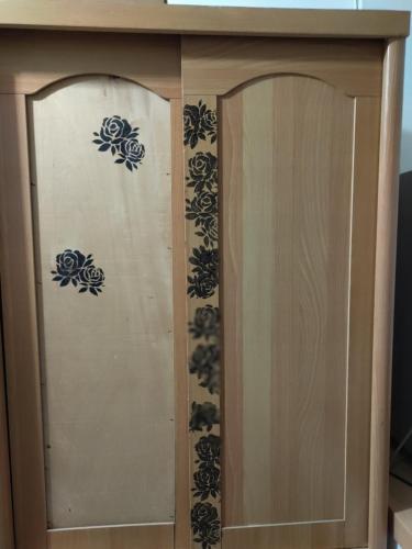 a wooden cabinet with blue flowers on it at 雅斤-淡水 in Lun-ting
