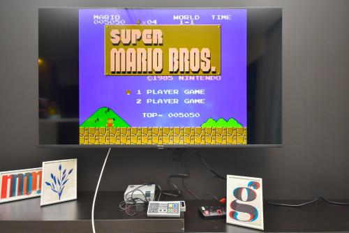 a tv screen with a super mario bros game on it at Almas Suite by Nest Home【Puteri Harbour & LEGOLAND】 in Nusajaya