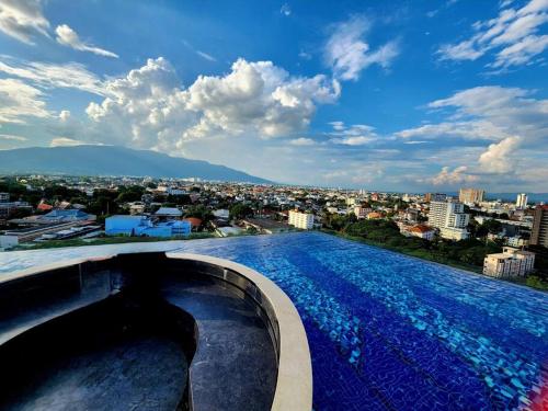 a swimming pool with a view of a city at The AstraSkyRiver Luxurious 2 Full Bedroom Condo - 73 SQM in Chiang Mai