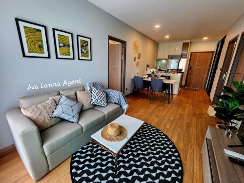a living room with a couch and a table at The AstraSkyRiver Luxurious 2 Full Bedroom Condo - 73 SQM in Chiang Mai