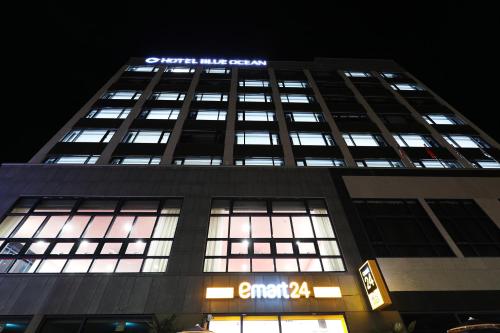 a tall building with a sign on top of it at Mokpo Ocean Hotel in Mokpo