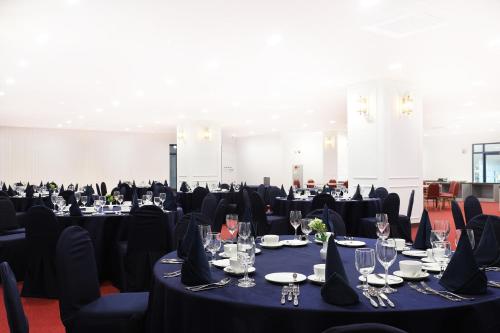 a room filled with tables and chairs with black tablecloths at Mokpo Ocean Hotel in Mokpo