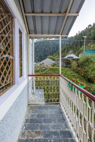 a balcony with a view of a mountain at Breezedale in Shimla