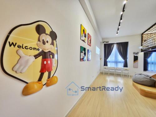 a room with a mickey mouse sign on the wall at Sunway GRID by SR Home in Kampong Pendas