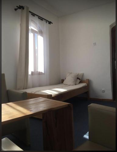 a room with two beds and a window at Iarimbato Hotel in Antananarivo