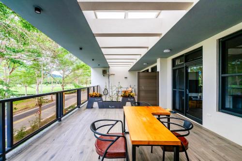 a large deck with a wooden table and chairs at Dream Field in Luye