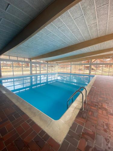 a large swimming pool in a building at l'écureuil in Saint-Laurent-en-Grandvaux