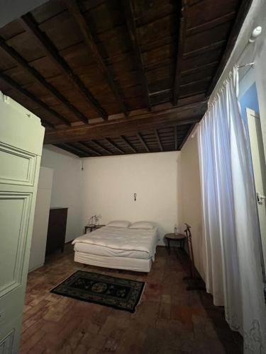 1 dormitorio con cama y techo de madera en Casa Otto, en Fara in Sabina