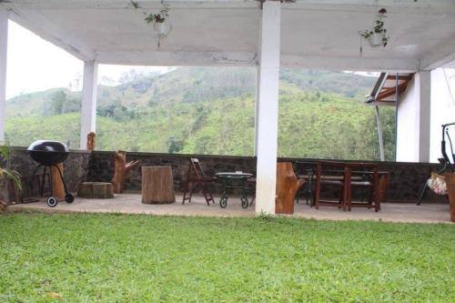 a screened in porch with a view of a mountain at M country home in Mirahawatta