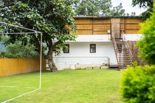 a house with a lawn with a goal at The Golden Sunrise Hotel in Nainital