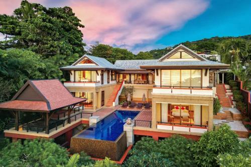 an aerial view of a house with a swimming pool at Seaview 5BR Pool Villa Apsara, Free Breakfast and Full Service, 5 min walk to Kata Beach in Kata Beach