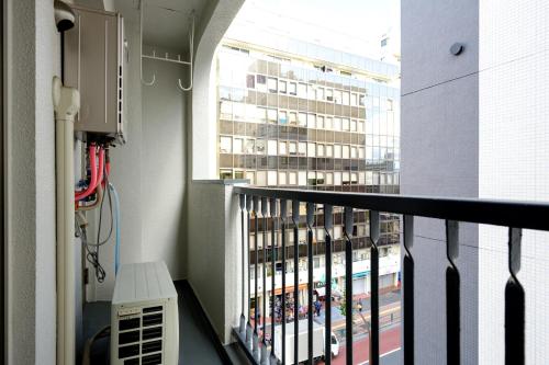 a balcony with a view of a large building at Home n Lounge in Tokyo