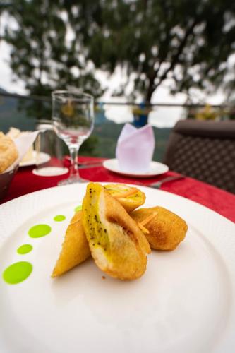 a white plate with some food on a table at The Golden Sunrise Hotel in Nainital